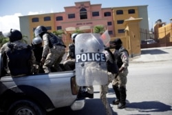 A Haitian National Police (PNH) officer walks towards a hotel, designated as a quarantine facility for the coronavirus disease (COVID-19), in Port-au-Prince, Haiti.