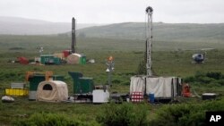 FILE - Workers with the Pebble Mine project test drill in the Bristol Bay region of Alaska near the village of Iliamna, July 13, 2007.