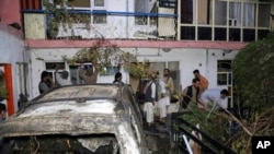 FILE - Afghans inspect damage to the Ahmadi family house after a U.S. drone strike in Kabul, Afghanistan, Aug. 29, 2021. 
