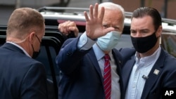 Democratic presidential candidate former Vice President Joe Biden waves as he arrives at The Queen theatre in Wilmington, Del., Oct. 19, 2020.