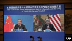 U.S. climate envoy John Kerry, right, meets with China's Foreign Minister Wang Yi via a video link during Kerry's visit in Tianjin, Sept. 1, 2021. (Photo by Handout / US Department of State / AFP) 