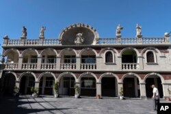 The Santa María de Guadalupe church parish office is decorated by the artisanry of Chimalhuacan stonecutters in Chilmalhuacan, once the ancient village of Xochiaca, Sunday, July 2, 2023. (AP Photo/Aurea Del Rosario)