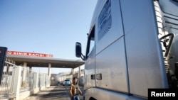 FILE - Syria-bound trucks, loaded with humanitarian supplies, arrive at Turkish Cilvegozu border gate, located opposite Syrian commercial crossing point Bab al-Hawa in Reyhanli, in the southern Hatay province, Turkey, Nov. 28, 2016.