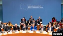 Participants attend the Libya summit in Berlin, Germany, Jan. 19, 2020, hosted by Chancellor Angela Merkel, seated in the center. To her right is United Nations Secretary-General Antonio Guterres.