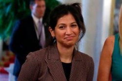 In this April 29, 2020, photo, Katie Miller, press secretary for Vice President Mike Pence, listens as President Donald Trump speaks about reopening the country, during a roundtable with industry executives in Washington.