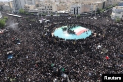 Mourners attend a funeral for victims of the helicopter crash that killed Iranian President Ebrahim Raisi and others, in Tehran, Iran, May 22, 2024. (West Asia News Agency via Reuters)