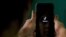 FILE - A mobile phone user opens the Chinese-owned video-sharing 'Tik Tok' app on a device in Bangalore, India, June 30, 2020.