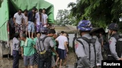 FILE - Chinese nationals, believed to be involved in illegal logging, arrive at a court in Myitkyina, capital of Kachin State in the north of Myanmar, July 22, 2015.