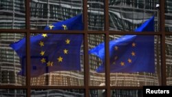 A European flag reflects in a building of the EU headquarters in Brussels. (File)