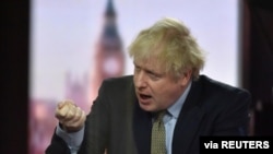 Britain's Prime Minister Boris Johnson gestures on BBC TV's The Andrew Marr Show in London, Britain, Jan. 3, 2021. Picture taken through glass. (Jeff Overs/BBC/Handout via Reuters)