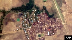 This handout satellite image from Planet Labs taken on May 23, 2020, and released by Human Rights Watch on May 26 shows Let Kar village in Myanmar's Rakhine state, after buildings in the village are believed to have been destroyed by fire.