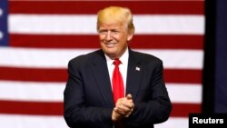 U.S. President Donald Trump takes the stage for a rally at the U.S. Cellular Center in Cedar Rapids, Iowa, June 21, 2017. 