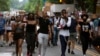 FILE - Demonstrators march near the White House as they protest police brutality and racism June 10, 2020, in Washington, DC. 