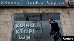 A man walks past a branch of Bank of Cyprus in Nicosia, March 31, 2013.