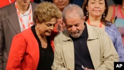 FILE - Brazil's former President Luiz Inacio Lula da Silva, right, looks at a document with Brazil's President Dilma Rousseff during a Central Workers Union convention in Sao Paulo, Brazil, Oct. 13, 2015. 