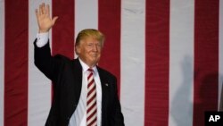 Republican presidential candidate Donald Trump waves during a campaign stop at the Jacksonville Equestrian Center in Jacksonville, Florida, Nov. 3, 2016.