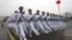 Chinese sailors march during a parade at a training base of China's North Sea Fleet (NSF) in Qingdao in east China's Shandong province on Monday, March 5, 2012. 