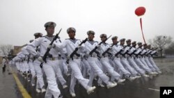 Chinese sailors march during a parade in Qingdao in east China's Shandong province, March 5, 2012. 