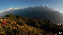 Para pendaki gunung menyaksikan matahari terbit di gunung Annapurna di Nepal tengah. (Foto: dok).