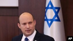 Israeli Prime Minister Naftali Bennett chairs the first weekly cabinet meeting of the new government in Jerusalem, Sunday, June 20, 2021. Bennett opened his first Cabinet meeting with a condemnation of the newly elected Iranian president, whom he…