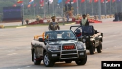 Commander-in-chief Min Aung Hlaing rides on a vehicle during a parade to mark Armed Forces Day in Myanmar's capital Naypyitaw, March 27, 2016.