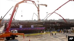 In this photo by the Atomic Energy Organization of Iran, concrete is poured for the base of the second nuclear power reactor at Bushehr plant, some 440 miles (700 kilometers) south of Tehran, Nov. 10, 2019. 