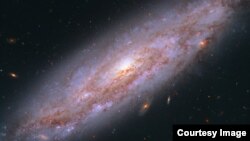 Hubble's view of a galaxy in Ursa Major, 65 million light-years away. (NASA, ESA, A. Riess (STScI/JHU)