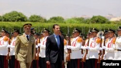 Syria's President Bashar al-Assad reviews a guard of honor before his swearing-in for a new seven-year term at the presidential palace in Damascus, July 16, 2014, in this picture released by Syria's national news agency SANA. 