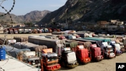 FILE - Trucks are parked at Pakistan-Afghanistan border Torkham, Oct. 19, 2018. 
