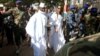 FILE - Gambian President Yahya Jammeh arrives at a polling station with his wife, Zineb, during the presidential election in Banjul, Gambia, Dec. 1, 2016.
