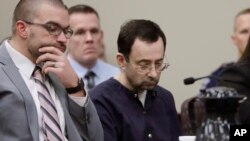 FILE - Larry Nassar sits with attorney Matt Newburg during his sentencing hearing, Jan. 24, 2018, in Lansing, Mich. 