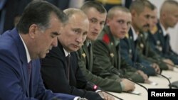 Russia's President Vladimir Putin (2nd L) and his Tajik counterpart Imomali Rakhmon (L) meet with servicemen as they visit a Russian military base in Dushanbe, October 5, 2012. 