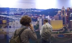 A declaration by a coalition of U.S. states, cities, businesses and other entities shows they are still committed to the Paris climate agreement. (Lisa Bryant/VOA)