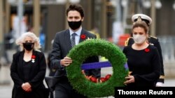 Canada's Prime Minister Justin Trudeau and his wife, Sophie Gregoire, attend a ceremony at the National War Memorial on Remembrance Day in Ottawa, Ontario, Canada, November 11, 2020.