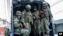 FILE - Soldiers patrol the perimeter of Inca prison during a state of emergency in Quito, Ecuador, Jan. 9, 2024, in the wake of the apparent escape of a powerful gang leader from prison. 