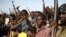 FILE - Jikany Nuer White Army fighters hold their weapons in Upper Nile State, February 2014.
