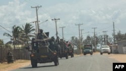 FILE - A military convoy of South Africa National Defense Forces patrols in Pemba, Aug. 5, 2021. The Southern African Development Community bloc is rallying behind neighboring Mozambique, sending troops to battle jihadists wreaking havoc in the north.