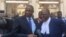 Tendai Biti, (R), opposition leader and member of Zimbabwe Lawyers for Human Rights, and Dzimbabwe Chibga from the rights group talk to reporters outside the High Court in Harare, Zimbabwe, September 2016. The two represented Zimbabwean opposition parties in court. (S. Mhofu/VOA)