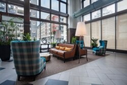 The Packard Motor Car Apartment Building's past history as a vehicle showroom is evident in its floor-to-ceiling windows, Philadelphia. (Courtesy Reinhold Residential)