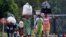 People displaced by fighting between Congolese forces and M23 rebels make their way home after spending a night in the Ugandan town of Bunagana, Oct. 31, 2013.