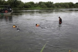 A U.S. Border Patrol Del Rio Sector Dive Team searches for a 2-year-old Haitian girl in Rio Grande River in Del Rio, Texas, July 2, 2019.