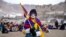A youth with his face painted in the colors of the Tibetan flag takes part in a demonstration to mark Tibetan Women's Uprising Day to commemorate the 1959 revolt against Chinese occupation of Tibet, at the Polo Ground in Leh, on March 12, 2025.