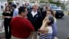 President Donald Trump talks to residents while taking a walking tour to survey hurricane damage and recovery efforts in a neighborhood in Guaynabo, Puerto Rico, Oct. 3, 2017. 