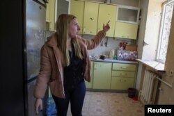 On April 8, 2024, local resident Kateryna Velnychuk, 22, shows the damage a Russian military strike did to her apartment on March 27. (Vyacheslav Madiyevskyy/Reuters)