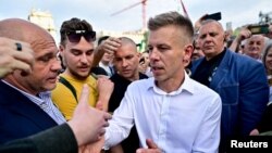 Peter Magyar, a lawyer and businessman formerly close to Hungary's ruling nationalist government, greets people during an anti-government protest led by him, in Budapest, Hungary, April 6, 2024.