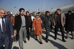 Hawa Alam Nuristani, chief of Election Commission of Afghanistan, center, leaves after a press conference at the Independent Election Commission office in Kabul, Afghanistan, Dec. 22, 2019.