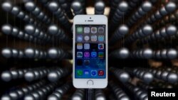 FILE - Apple's new iPhone 5S is displayed at an Apple shop in Tokyo's Ginza shopping district, Japan, Sept. 20, 2013.