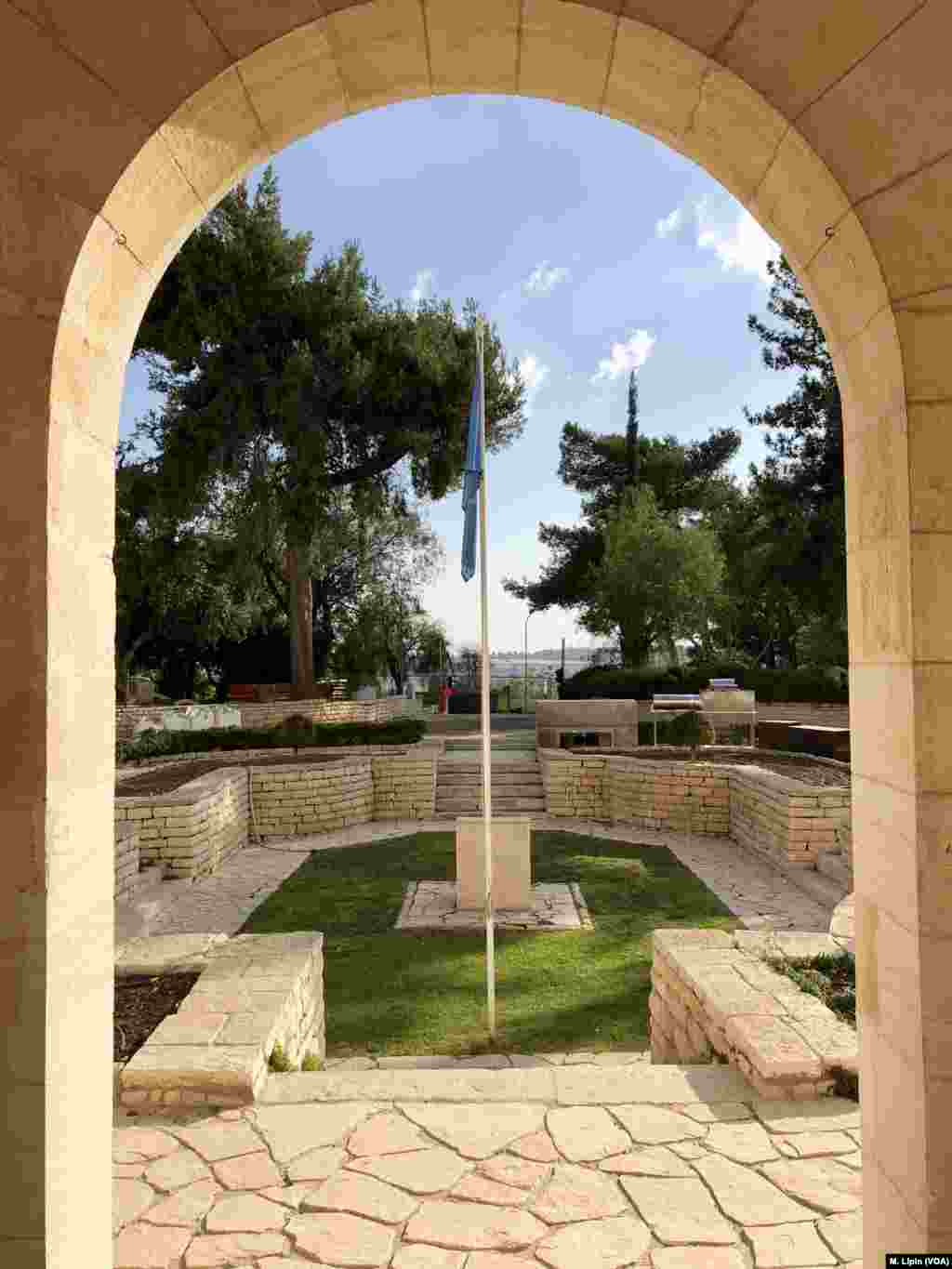 The view from the entrance of Government House, with the U.N. flagpole in the center of a courtyard, April 6, 2018. 