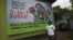 A man walk past a giant advertisement bill board of Nigeria Globacom in Lagos, May, 13. 2012.