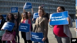 Activists with Planned Parenthood demonstrate in support of a pregnant 17-year-old being held in a Texas facility for unaccompanied immigrant children to obtain an abortion, outside of the Department of Health and Human Services in Washington, Oct. 20, 2017.